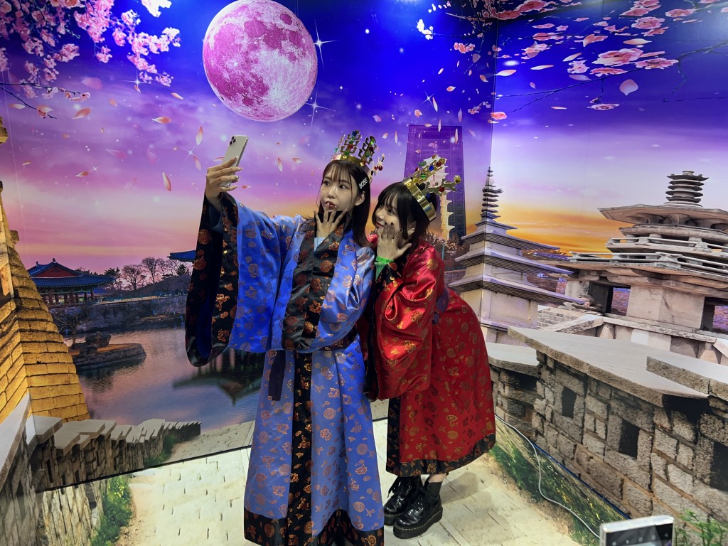 일본 관람객들이 신라복장과 왕관을 쓰고 포토존을 배경으로 사진을 찍고 있다